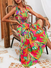 Tropical tie-strap smocked midi dress in strawberry with a vibrant leaf print.
