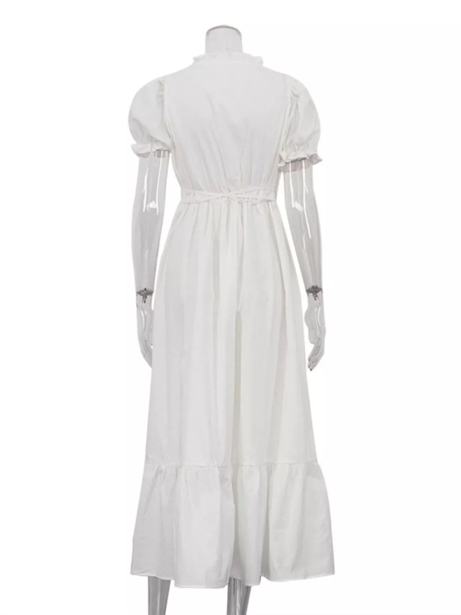 White cotton midi dress with puff sleeves, ruffled neckline, and tiered hem