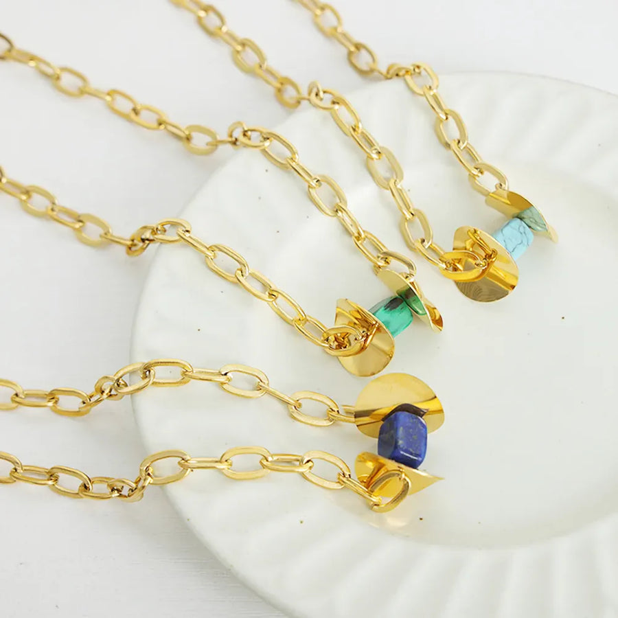 Geometric malachite pendant necklace with 18K gold-plated chain, featuring light blue, dark green, and dark blue stones.