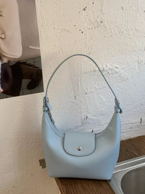 Elegant mini crescent hobo bag in blue with a flap closure and silver hardware.