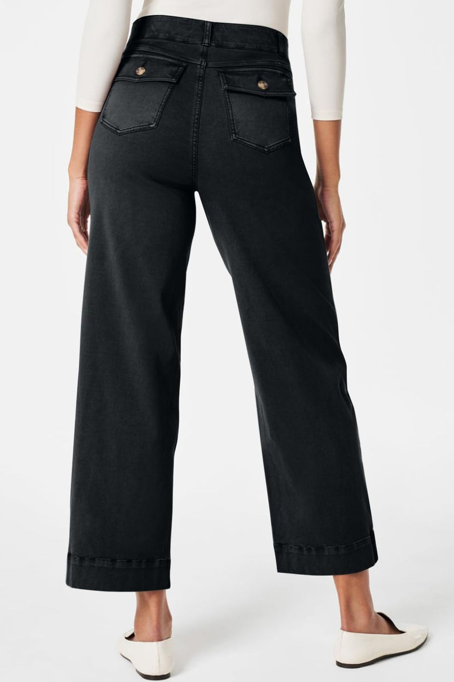 Wide-leg utility denim trousers in black with buttoned flap back pockets.