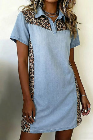 Denim shirt dress with leopard print panels, collared neckline, short sleeves, and a button placket.