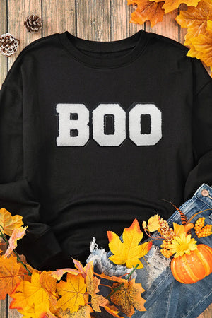 Black crewneck sweatshirt with white varsity "BOO" graphic and distressed denim.