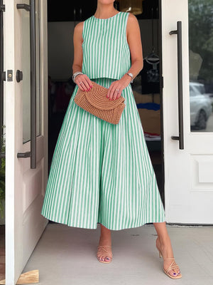 Green and white striped sleeveless crop top and pleated midi skirt set with pockets.