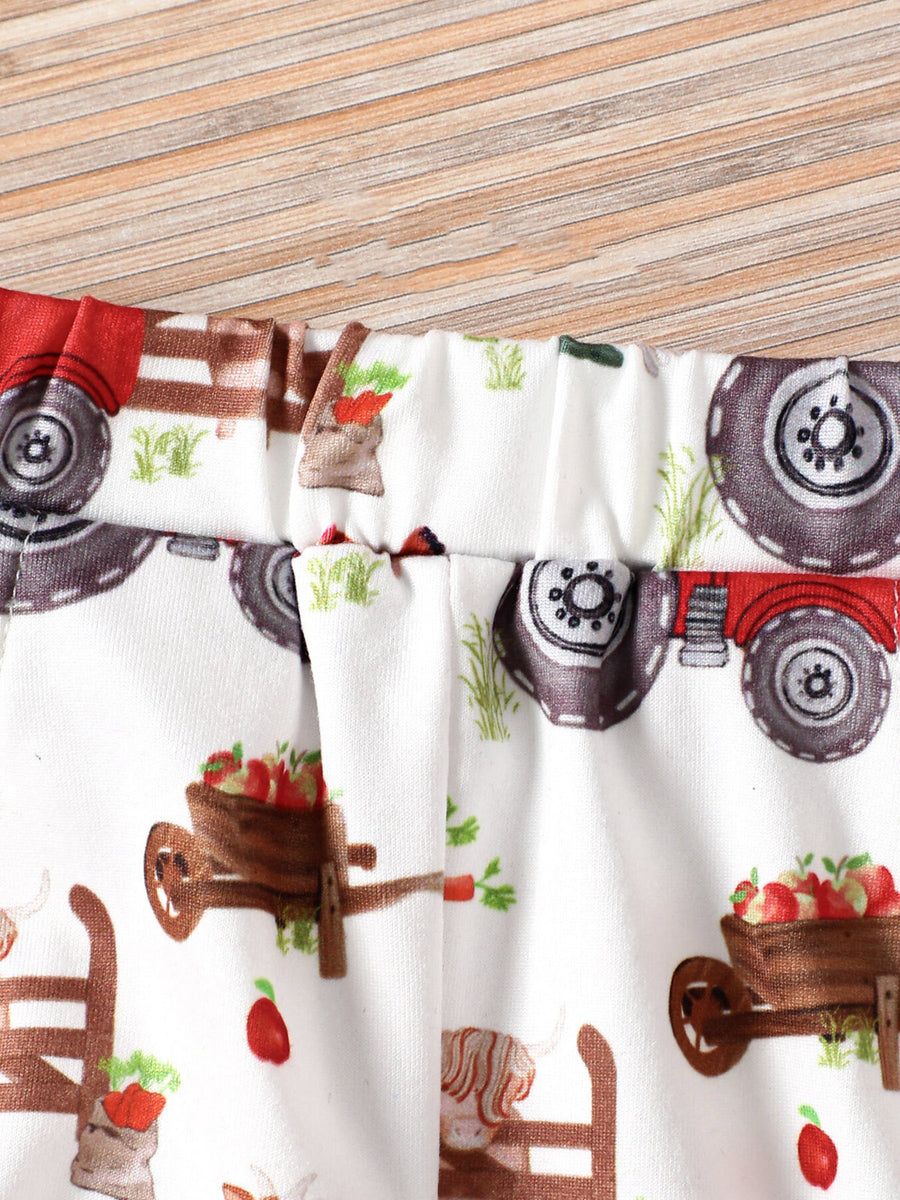 Baby shorts with elastic waist and farm tractor print on cotton blend fabric.