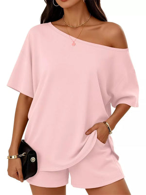 Pink boat neck tee and shorts set with off-the-shoulder styling and pockets.