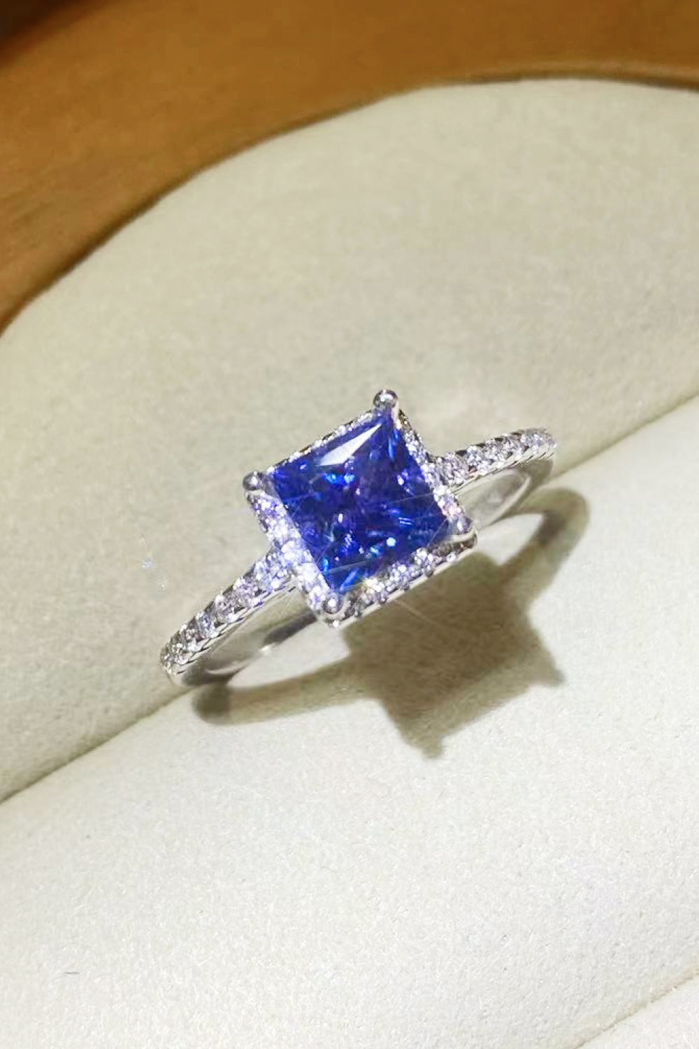 Blue sapphire square halo ring with pave diamond band