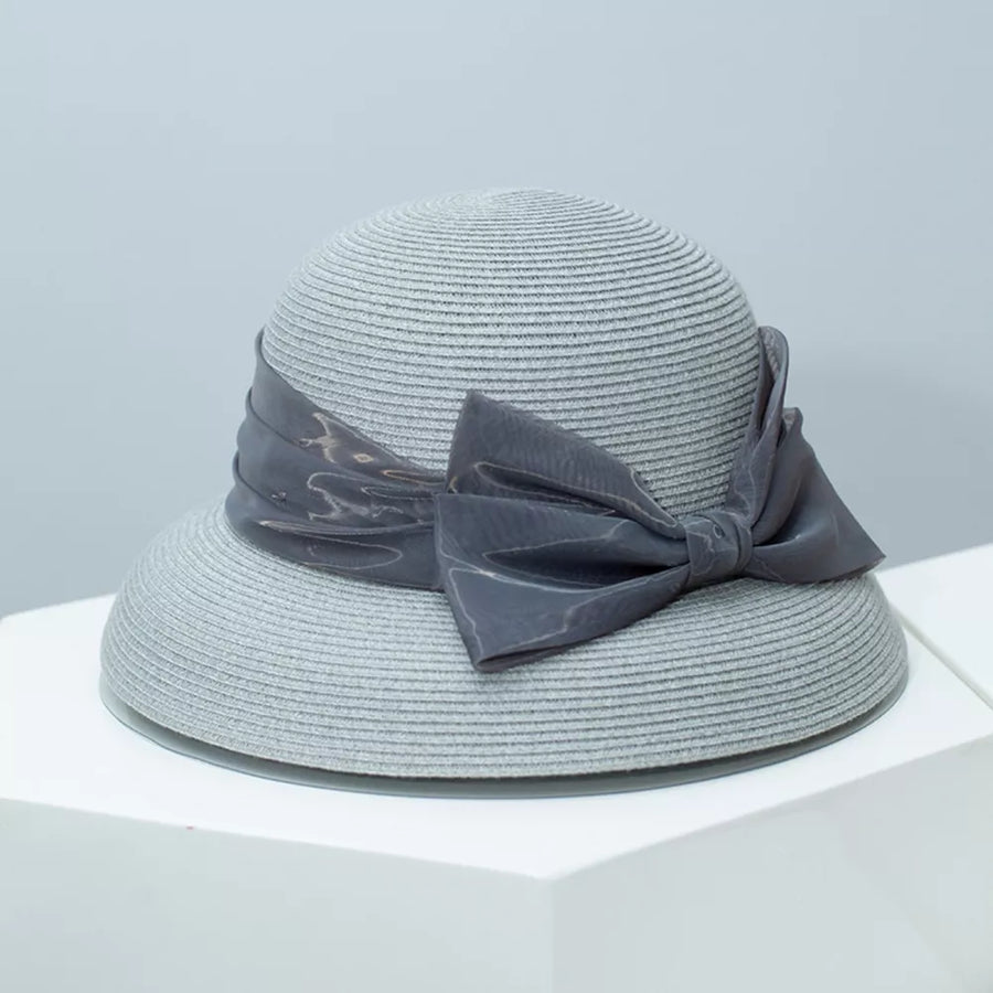 Gray straw sun hat with a large satin bow detail.
