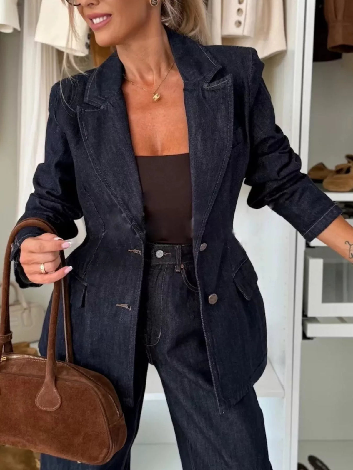 Dark navy denim blazer with a tailored fit, notched lapels, and button closure.