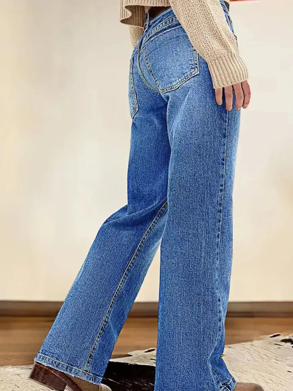 Light blue denim straight leg jeans with vintage wash and buttoned fly.