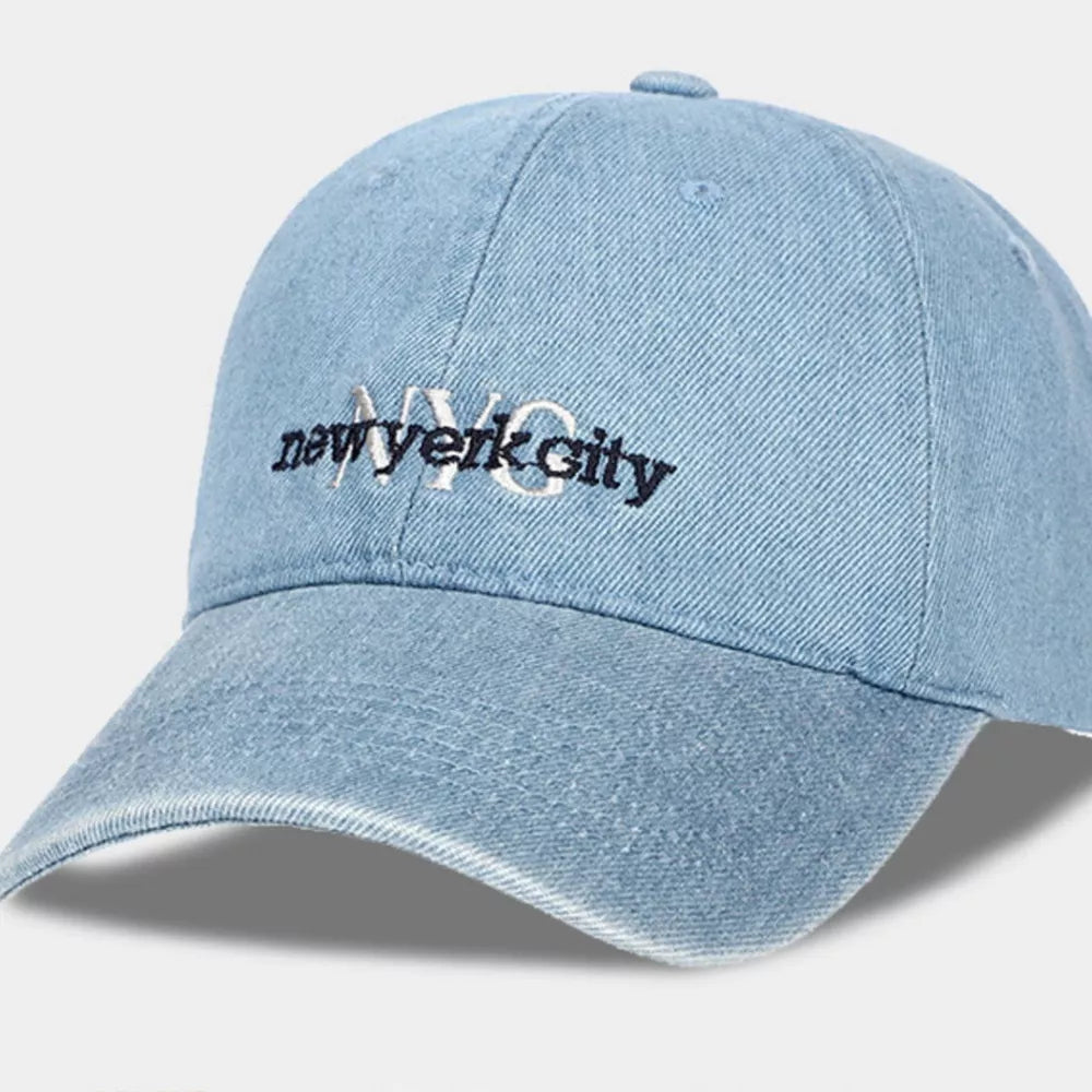 Light blue denim baseball cap with embroidered NYC text and distressed brim.