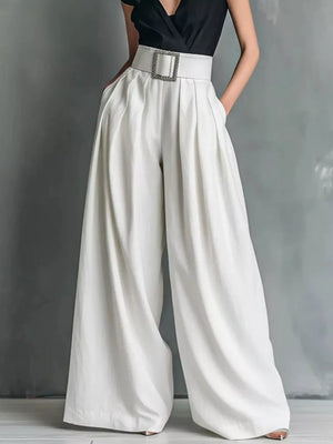 Belted high-waisted wide-leg pants in white with a decorative buckle, styled with a black top.