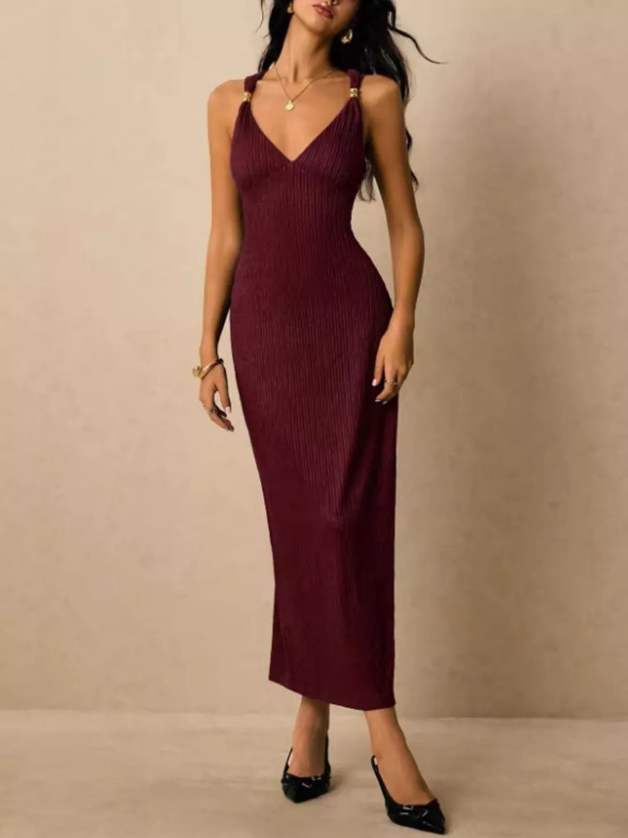 Burgundy ribbed midi dress with crisscross straps and gold hardware detail.