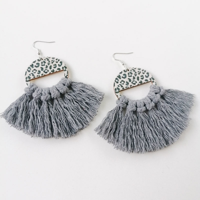 Leopard print fan earrings with dark gray tassels and wooden accents