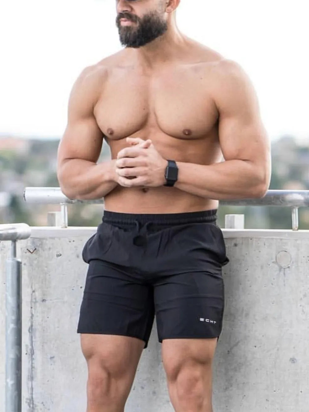 Black athletic shorts with drawstring and subtle logo detail.