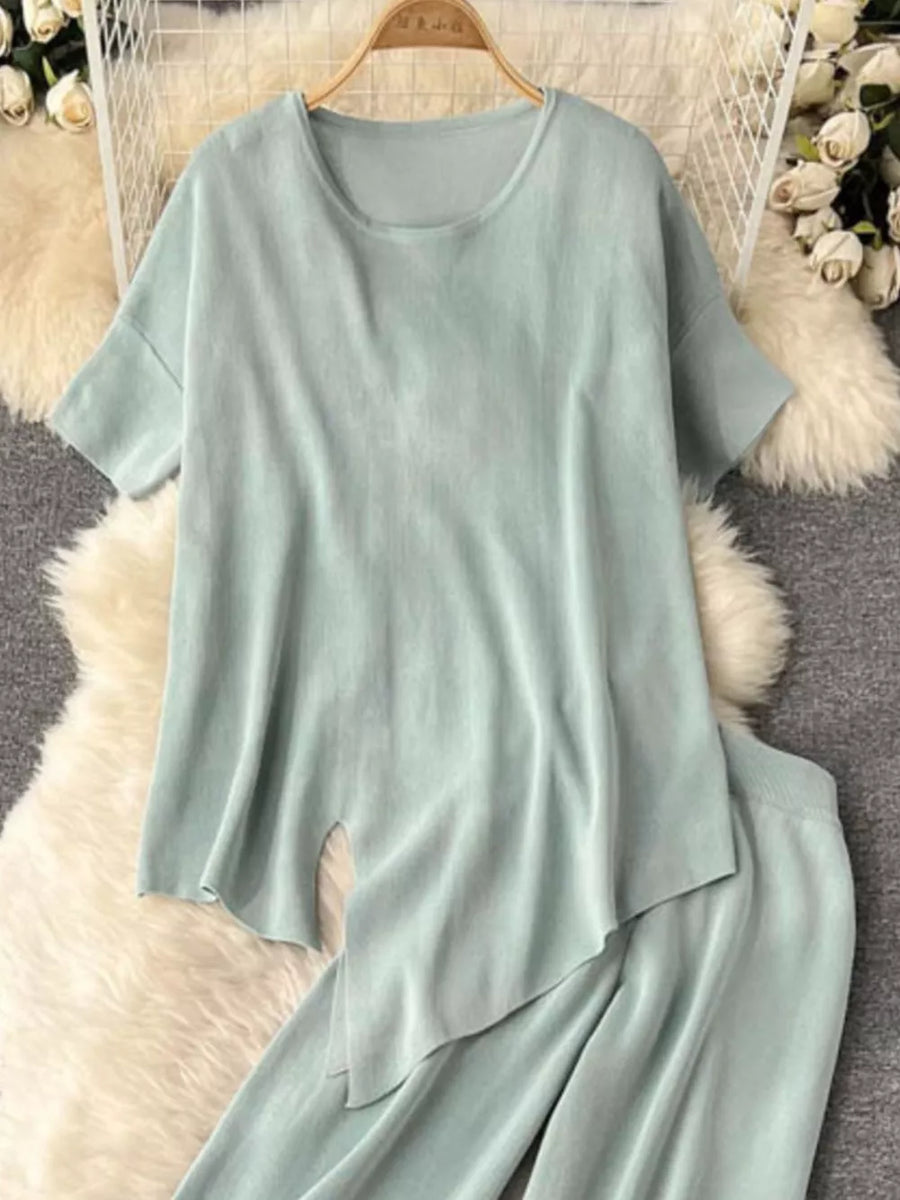 Light green tied waist two-piece set with wide leg pants and asymmetric top.