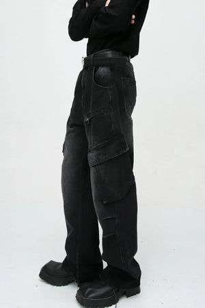 Baggy black denim cargo pants with zipper pockets and large flap pockets.