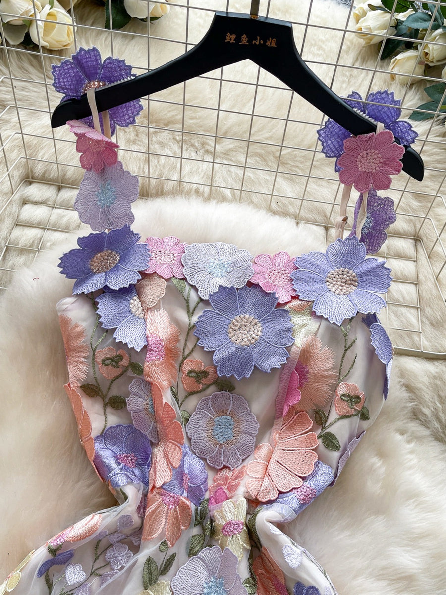 Embroidered floral mini dress with 3D flowers on straps and neckline in pastel colors.