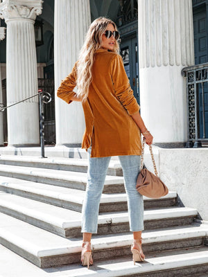 Velvet blazer in caramel with drape-front and button detail, styled with jeans.