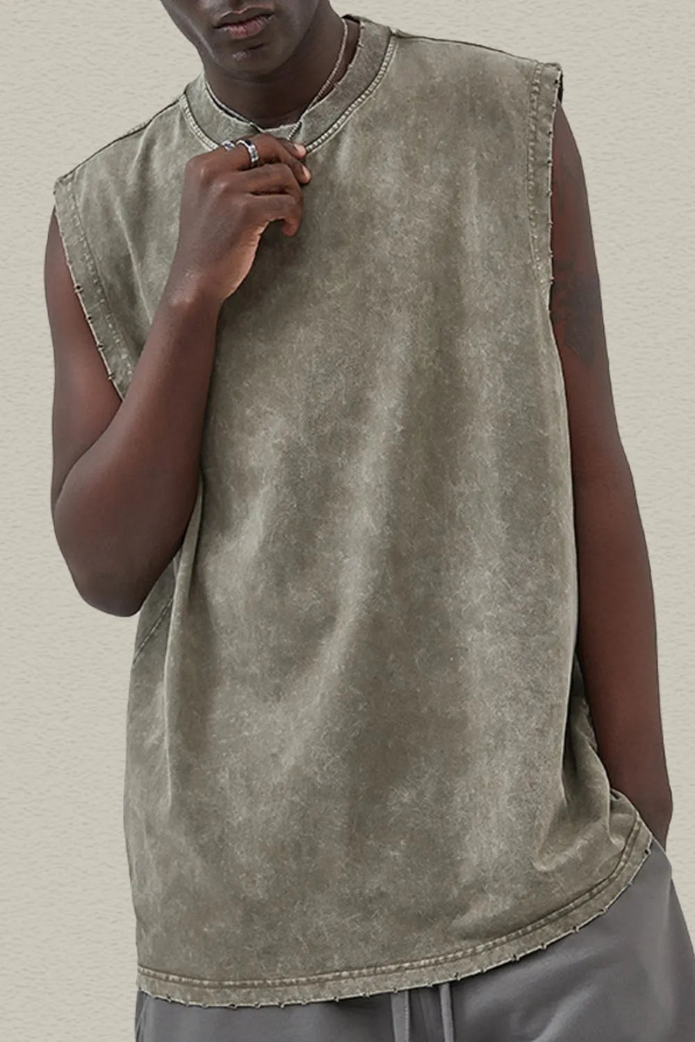 Acid wash muscle tank top in moss with raw edge sleeves and neckline.