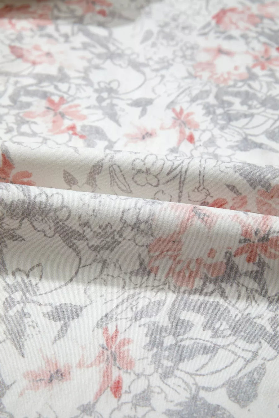 Floral print wide-leg jeans in cotton with pink and grey floral pattern on white.