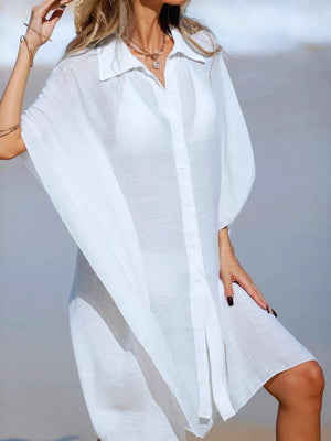 White button-up cover-up with short sleeves and a relaxed fit, styled over a bikini.