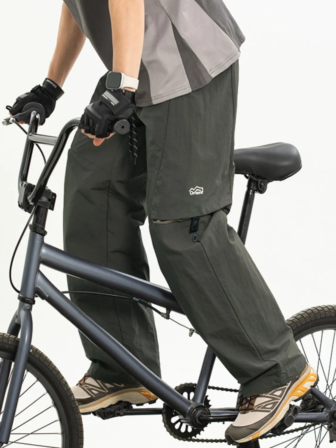 Convertible cargo pants in army green with zip-off legs and utility pockets.
