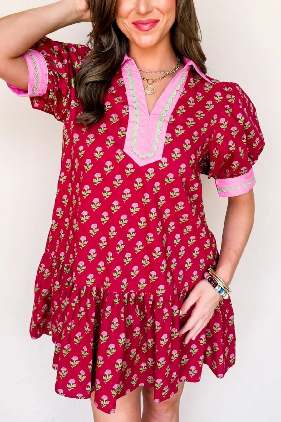 Red floral mini dress with V-neck, puff sleeves, and ruffled hem.