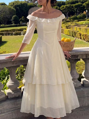 Cream ruffled off-shoulder midi dress with tiered skirt and airy fabric.