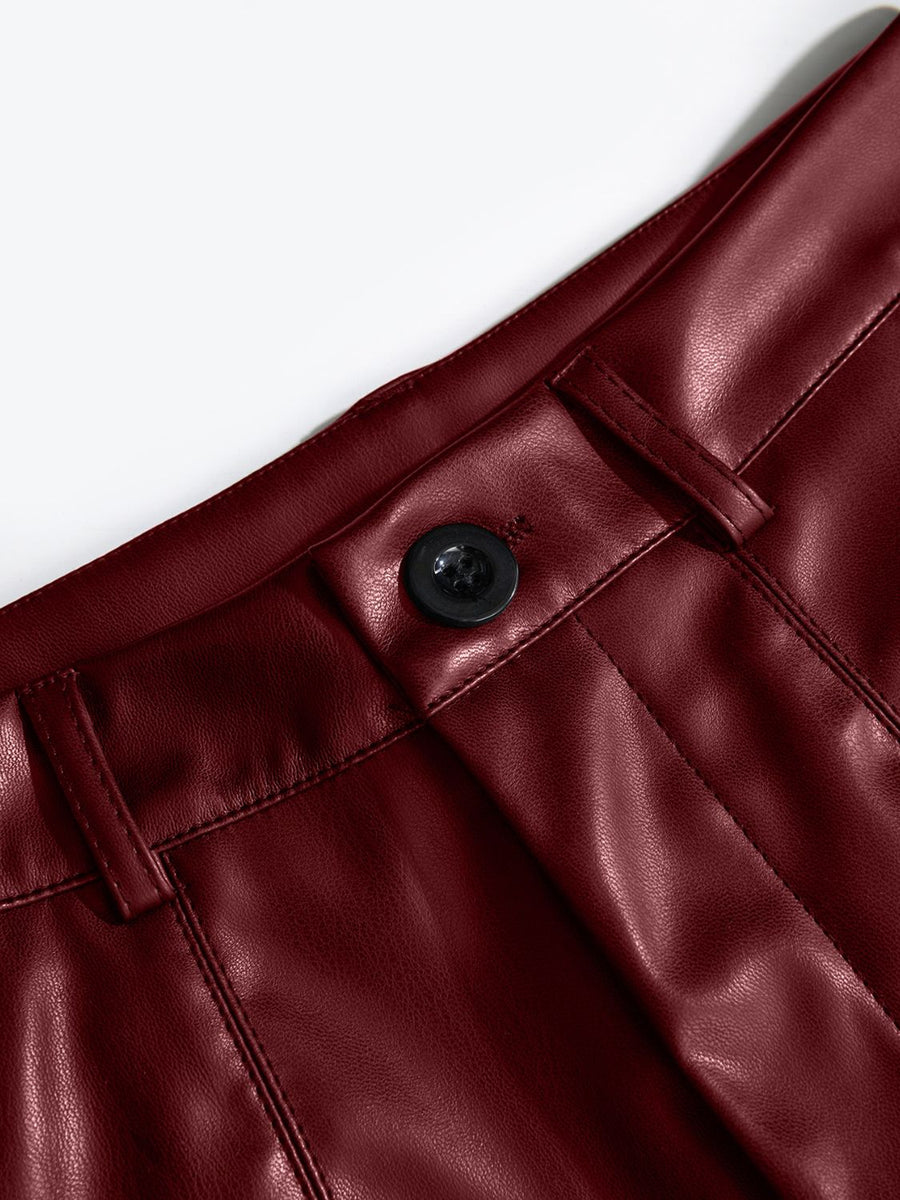 Burgundy vegan leather bermuda shorts with button closure and belt loops.