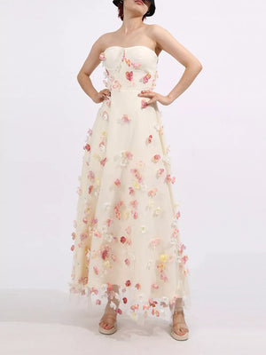 Strapless ivory tulle maxi dress with romantic floral appliques and sweetheart neckline.