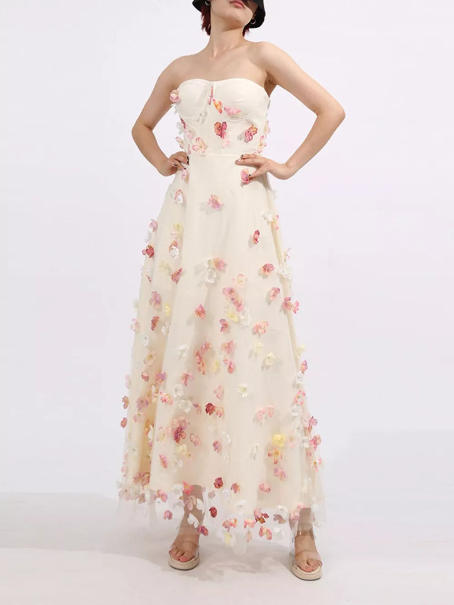 Strapless ivory tulle maxi dress with romantic floral appliques and sweetheart neckline.