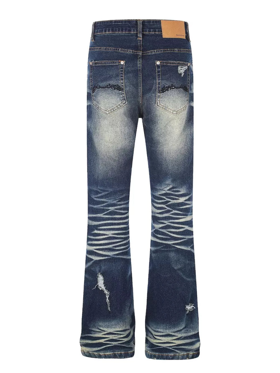 Distressed dark wash flare jeans with pocket details and button fly.