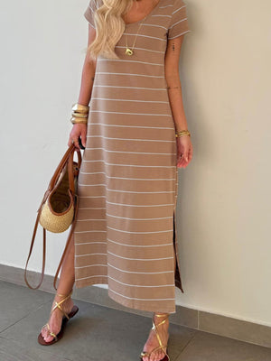 Brown striped maxi t-shirt dress with short sleeves and side slits, styled with gold sandals.