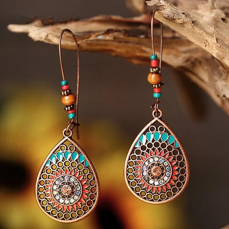 Bohemian mandala drop earrings in copper with turquoise and red accents.