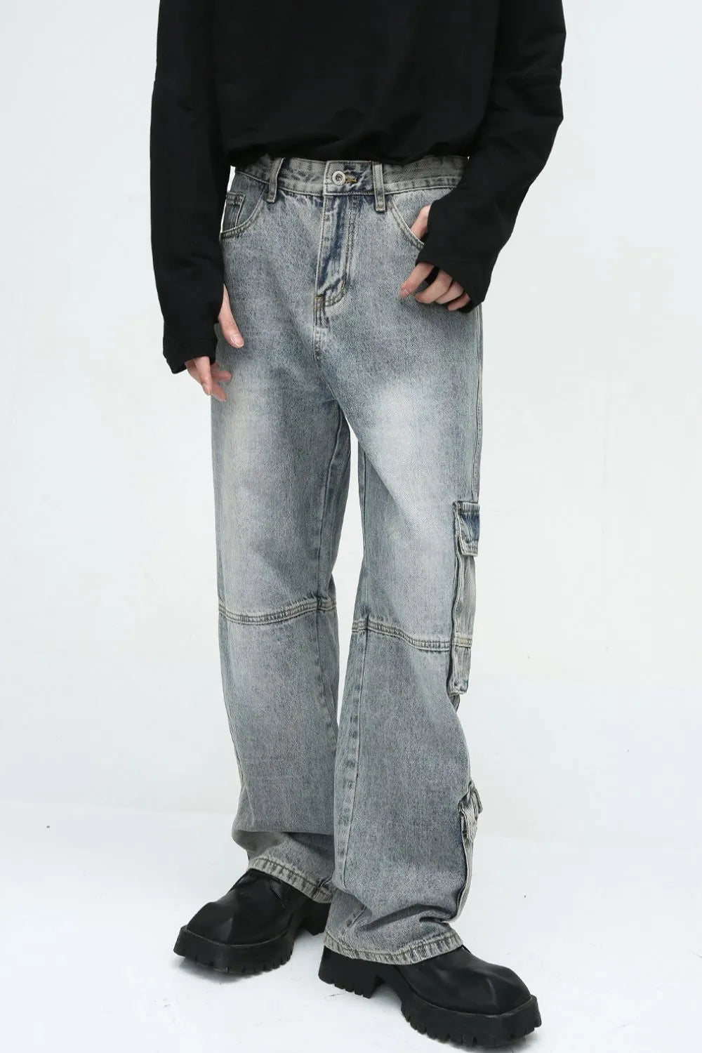 Medium wash wide leg cargo jeans with utility pockets and a relaxed fit.