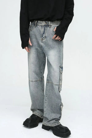 Medium wash wide leg cargo jeans with utility pockets and a relaxed fit.