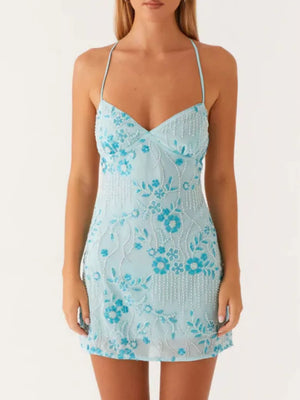 Pastel blue mini dress with floral embroidery and beaded fringe detail.