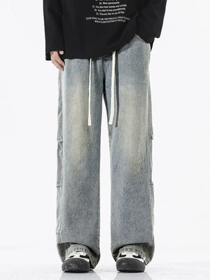 Men's light wash vintage distressed wide leg jeans with drawstring waist.