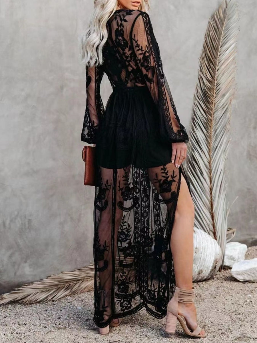 Black floral lace maxi dress with bell sleeves and a high slit, worn over shorts.