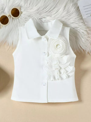 White collared sleeveless top with decorative ruffles and button detail.