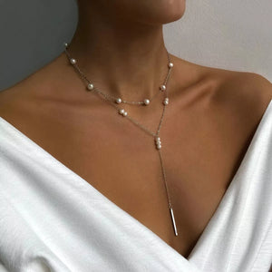 Double layered silver Y-shaped necklace with pearls and a bar pendant.