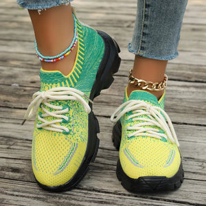 Vibrant two-tone yellow and green lace-up sneakers with chunky soles and ankle collars.