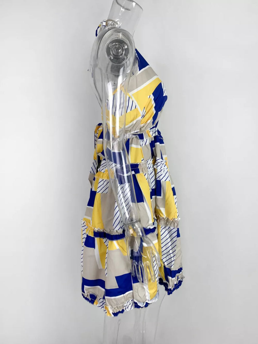 Abstract print halter mini dress with yellow, blue, and gray geometric pattern and tiered ruffles.