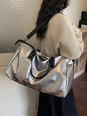 Sleek silver metallic large travel bag with adjustable strap and detachable pouch.