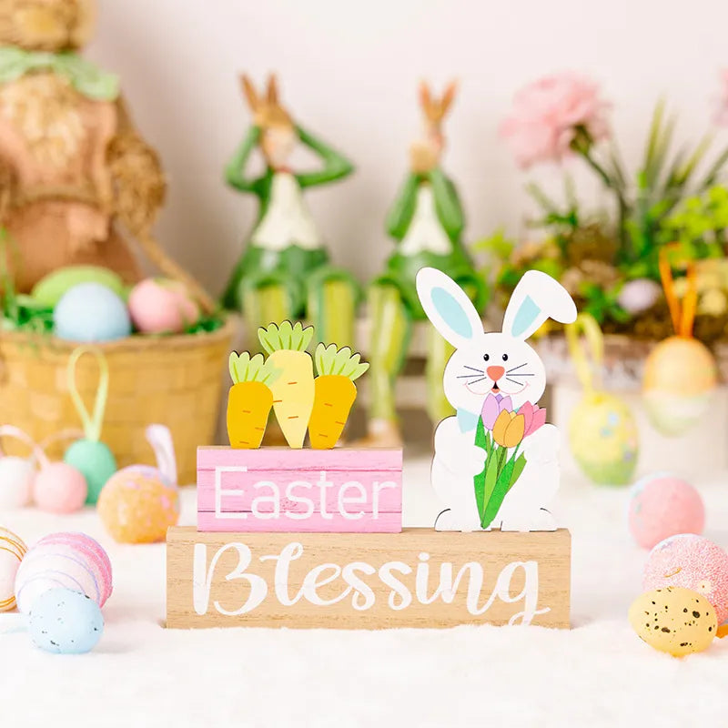 Easter wooden gnome trio display with bunny and carrots on pink and wood blocks.