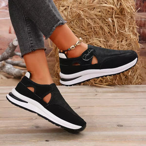 Black cutout slip-on sneakers with white soles and "Fashion" detail.