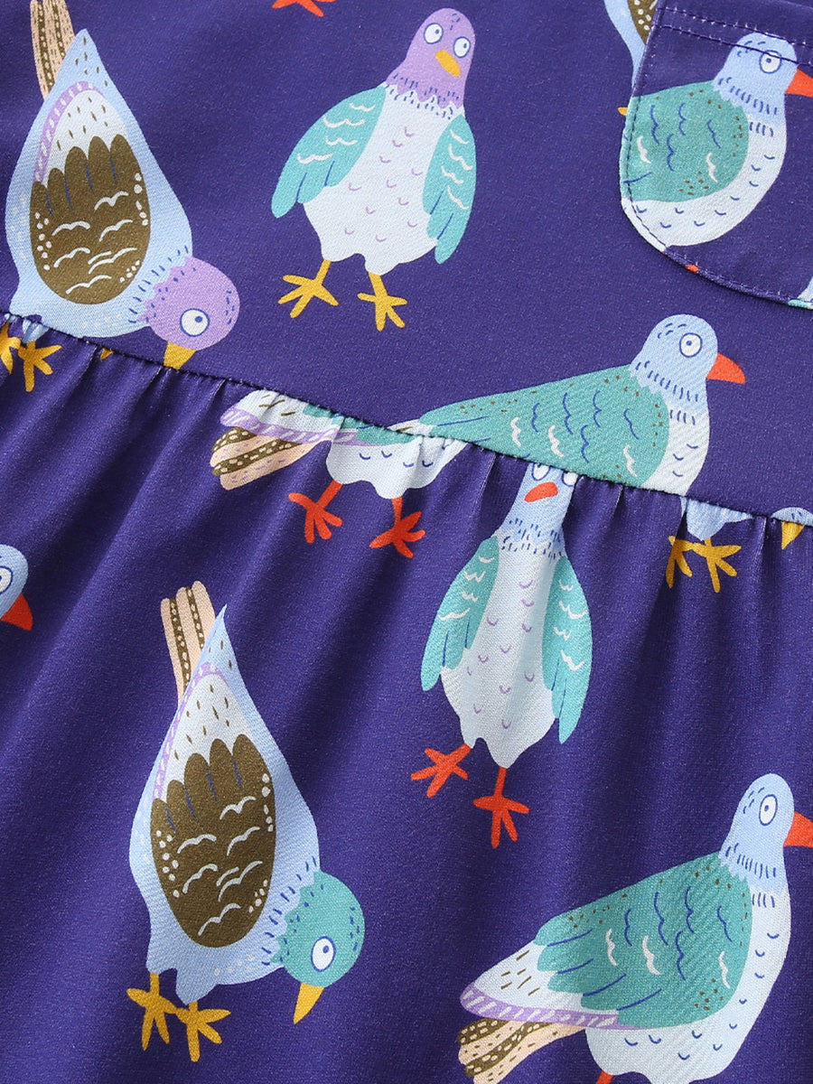 Toddler dress in purple with a playful pigeon print, featuring a ruffled hem detail.