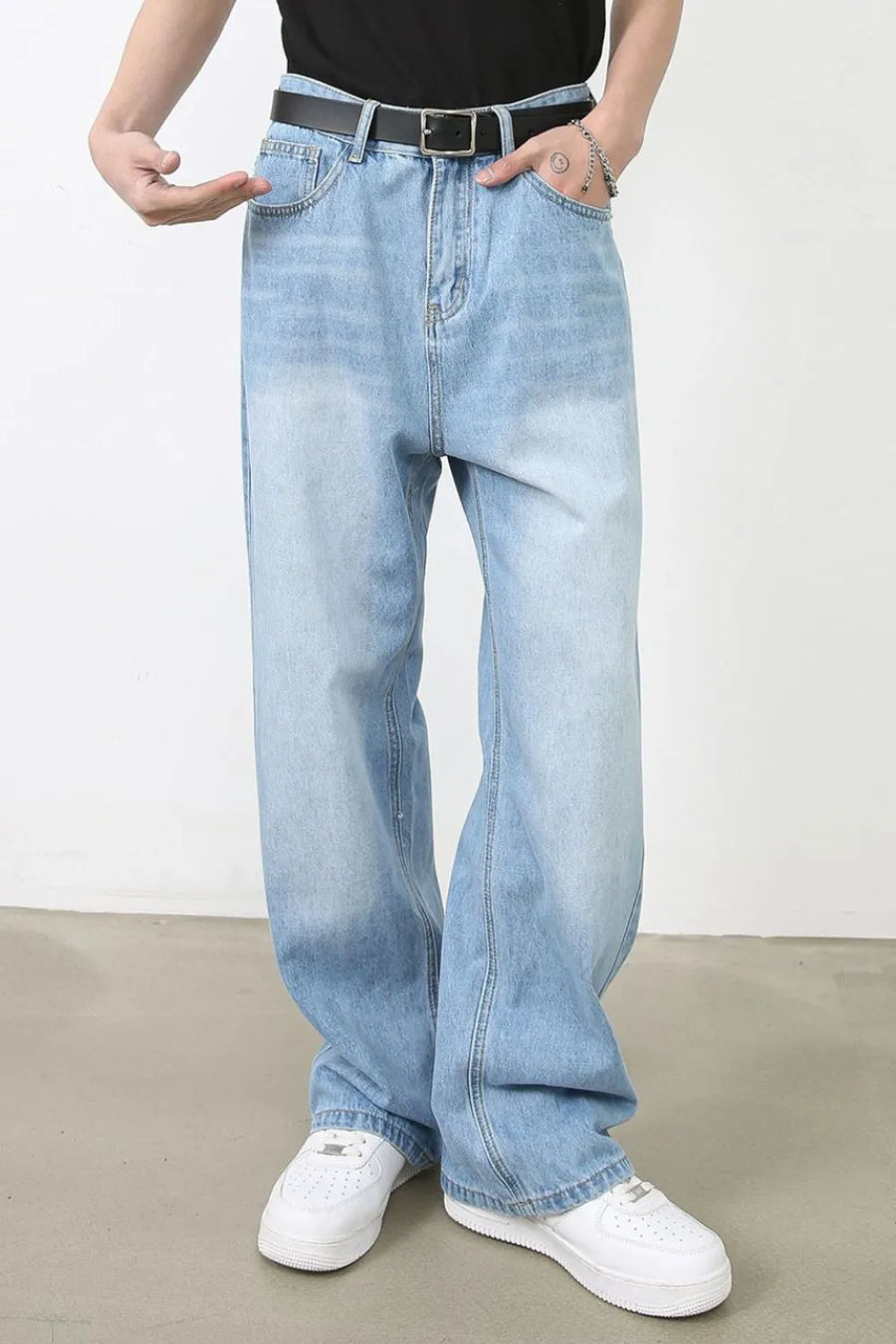 Faded light blue denim baggy jeans with a relaxed fit.