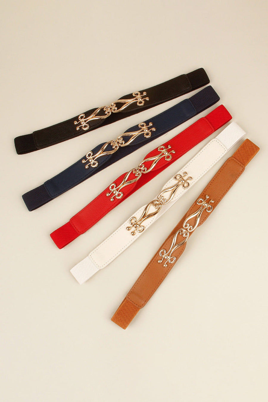 Elastic belts in black, dark blue, red, white, and caramel with ornate alloy clasps.